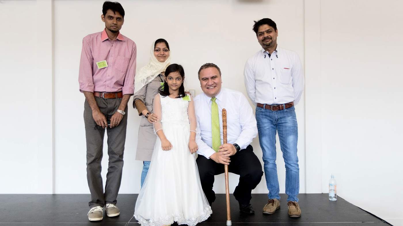 Say cheese: Salman, Hibbah, Attia and Hibbah’s brother Sarfraz (far right), pose with staff member Stephen Huinga, after a welcome at the Mangere centre.