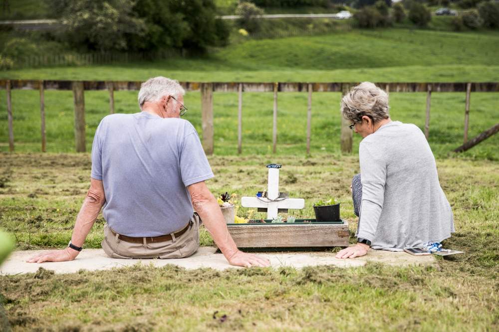 Nicholas&#39;s parents, Nelson and Margaret at his grave.  (CHRISTEL YARDLEY\/STUFF)