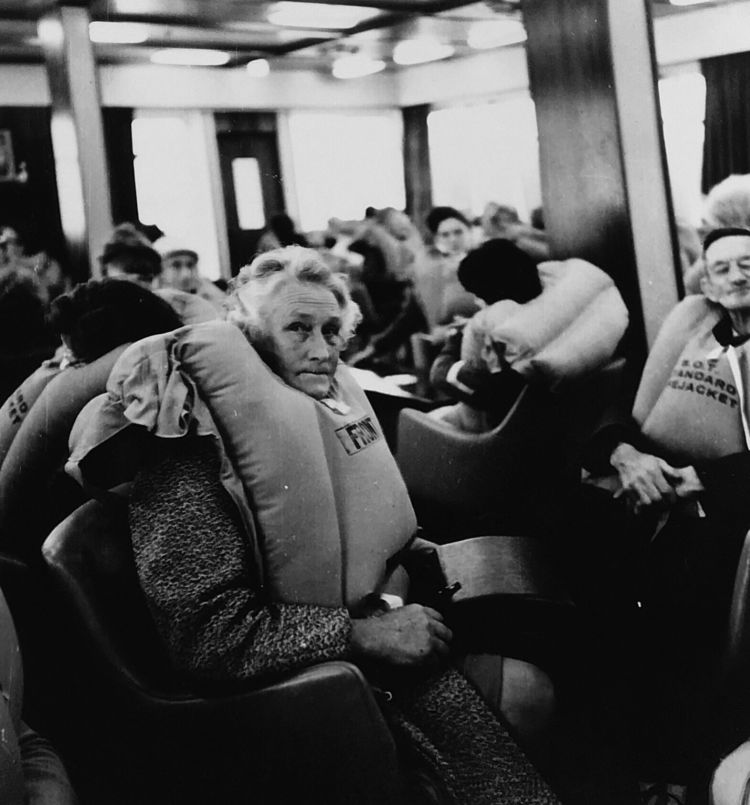 In the smokeroom on B deck, passengers patiently sat in their bulky orange lifejackets for more than six hours, awaiting further instructions. FRANK ROBINSON