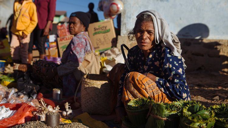 An elderly woman selling produce at the markets in Letefoho