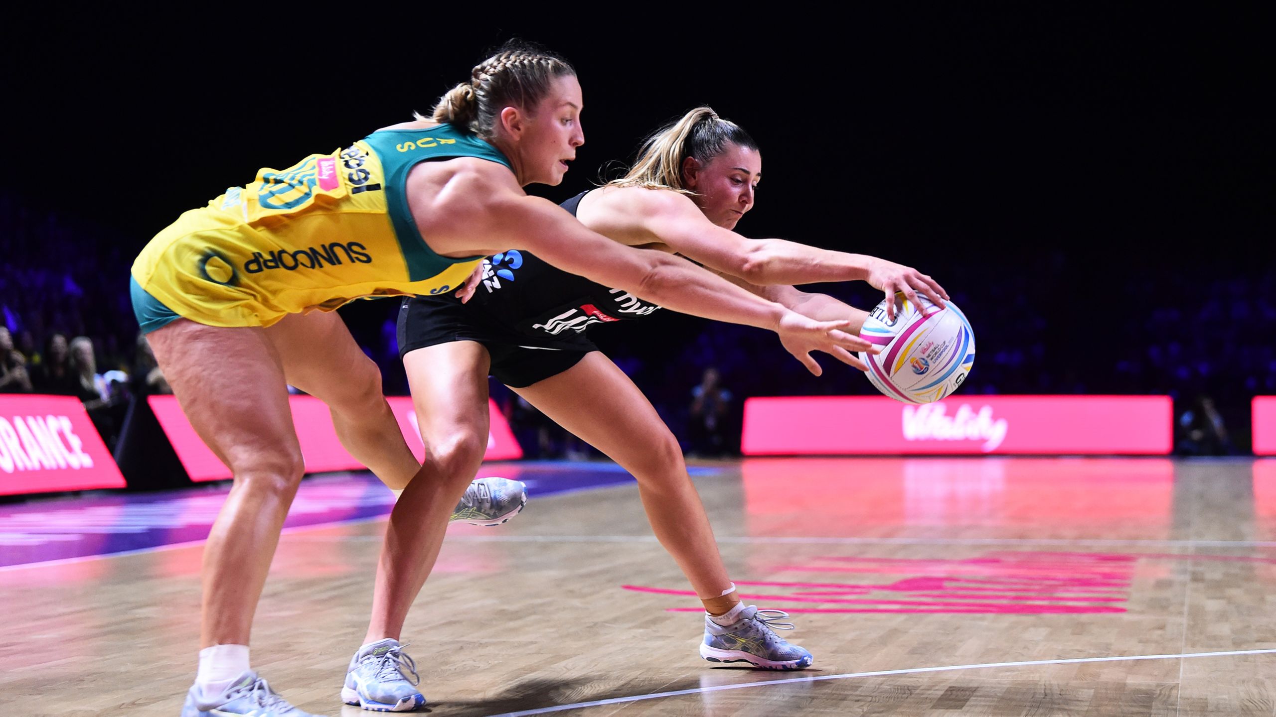 Jamie-Lee Price of Australia and Gina Crampton of New Zealand reach for the ball
