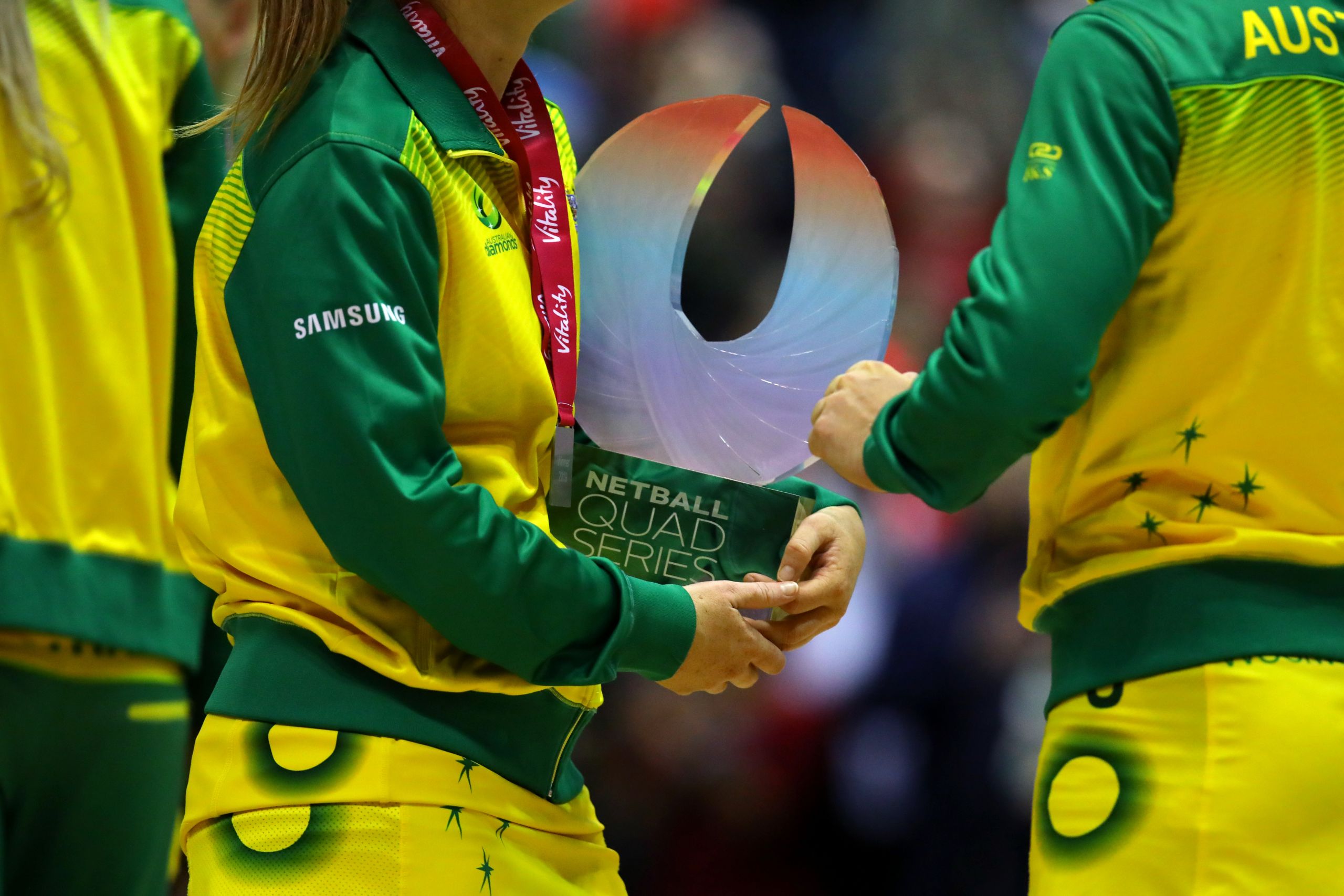 Quad Series trophy held by Australian team member