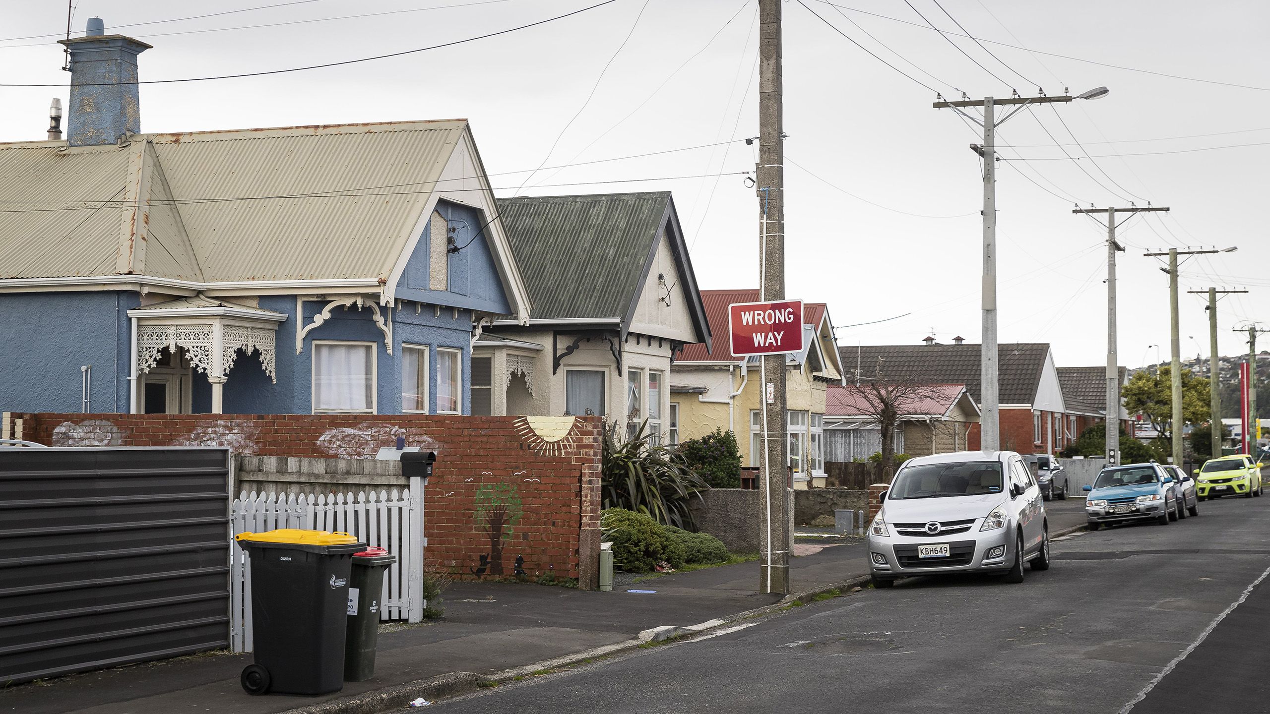 Houses tightly packed together on a South Dunedin street.