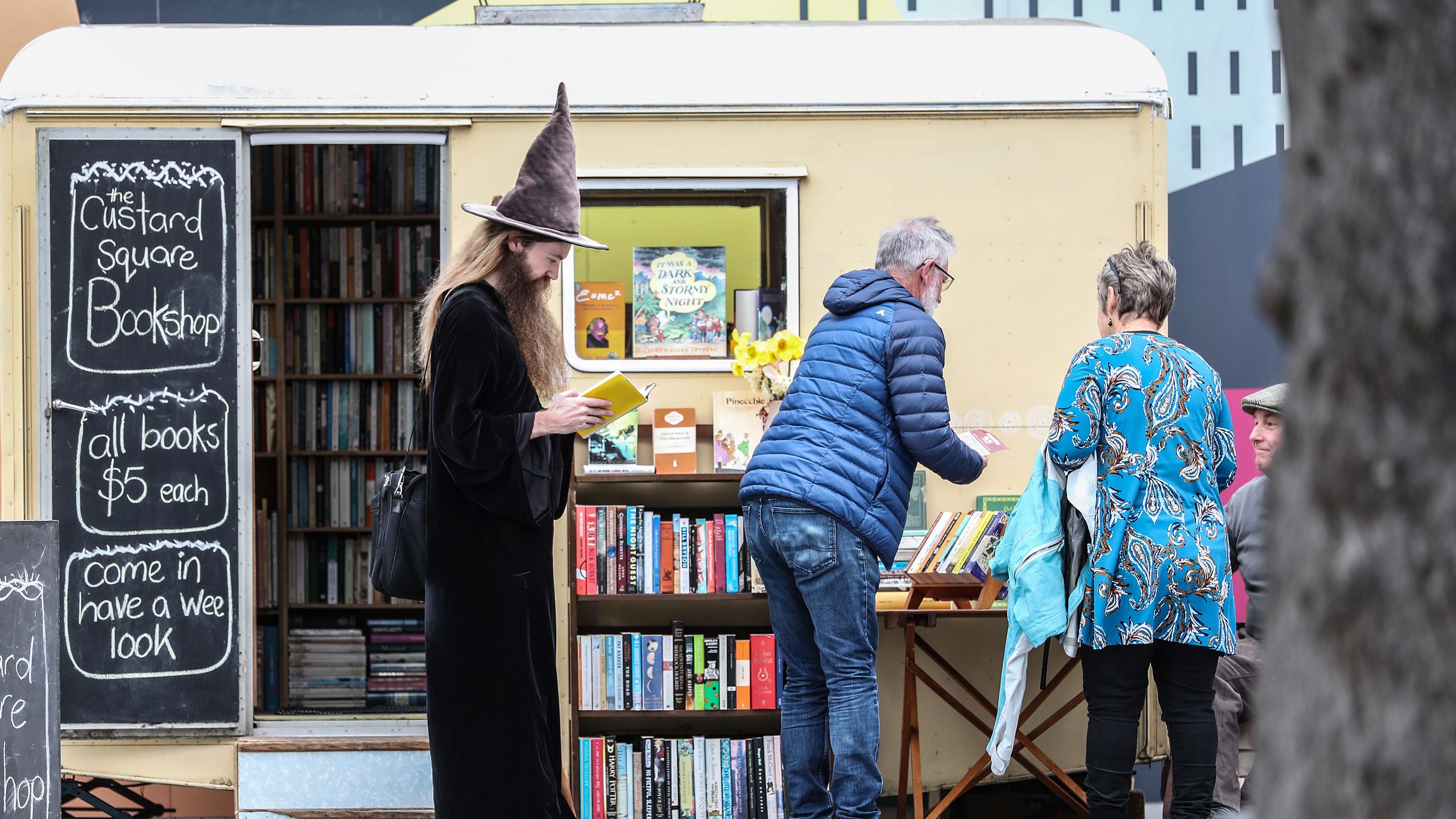 Ari browsing through a book outside the Custard Square Bookshop in Christchurch.