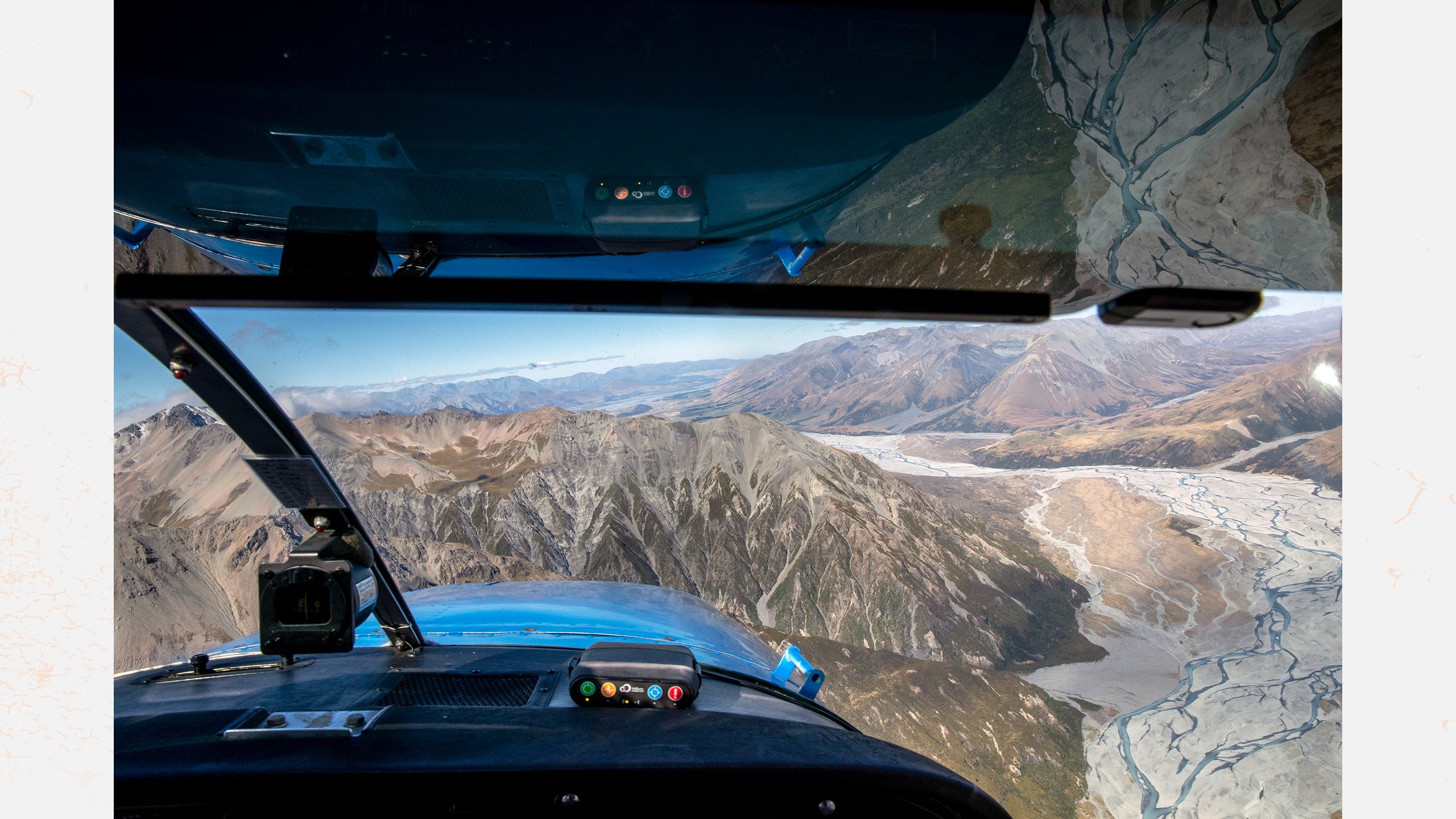 Looking out the front of a light aircraft onto Lake Heron Station in Canterbury.