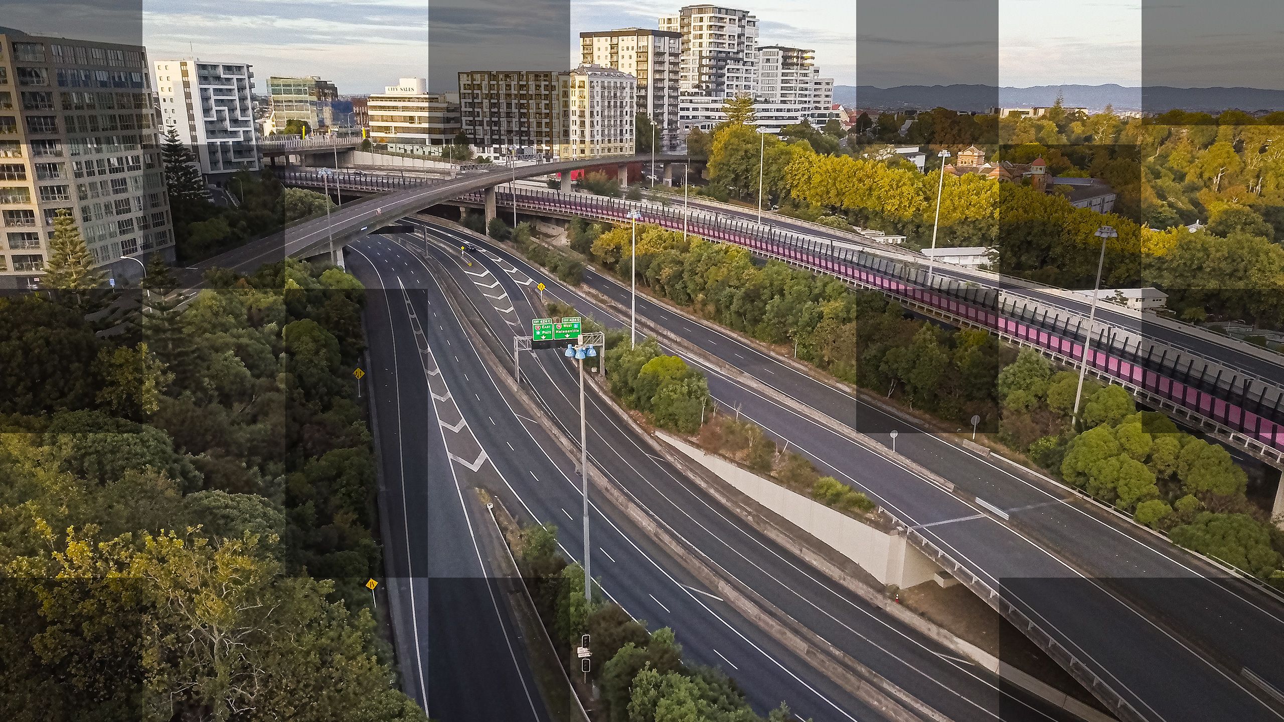 Same photo of the motorway but with more squares in a grid pattern revealing a lighter version of the same image.