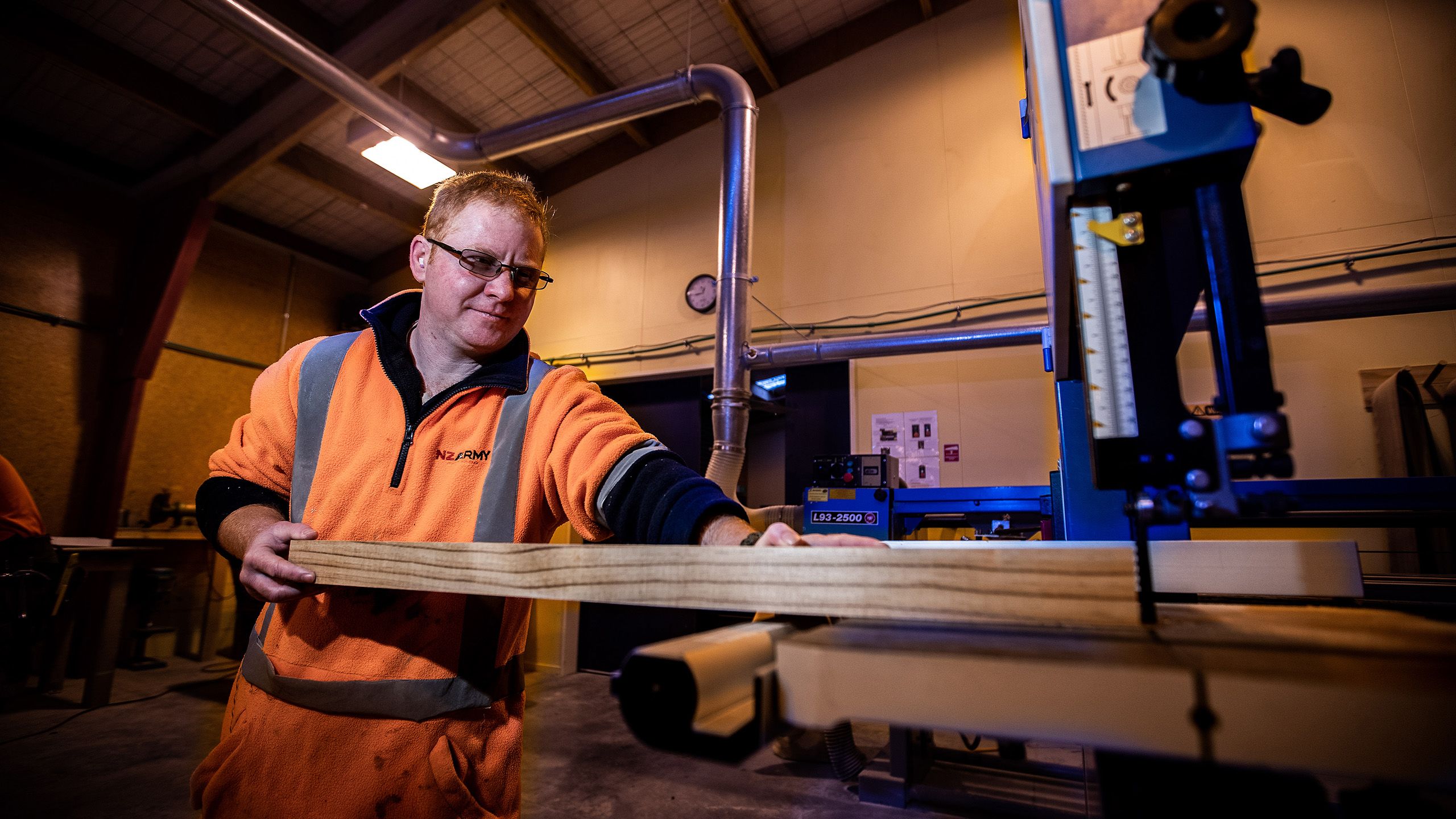 Tony saws some wood in his role as a carpenter.