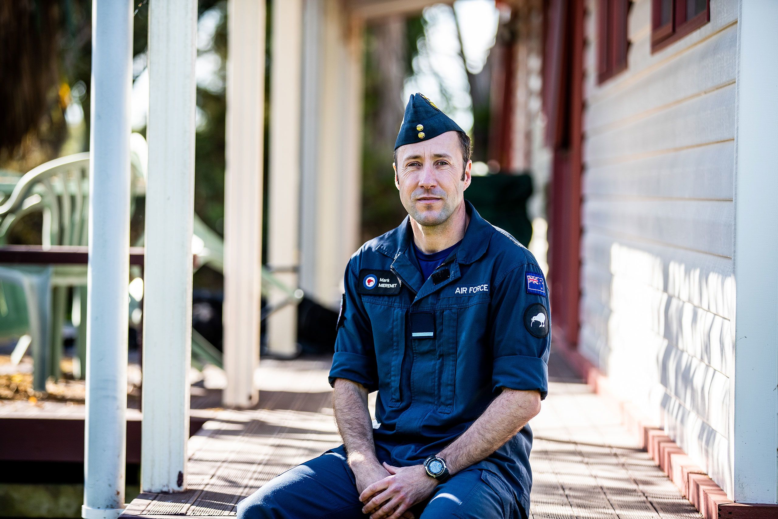 Mark sits on his veranda wearing his airforce uniform.