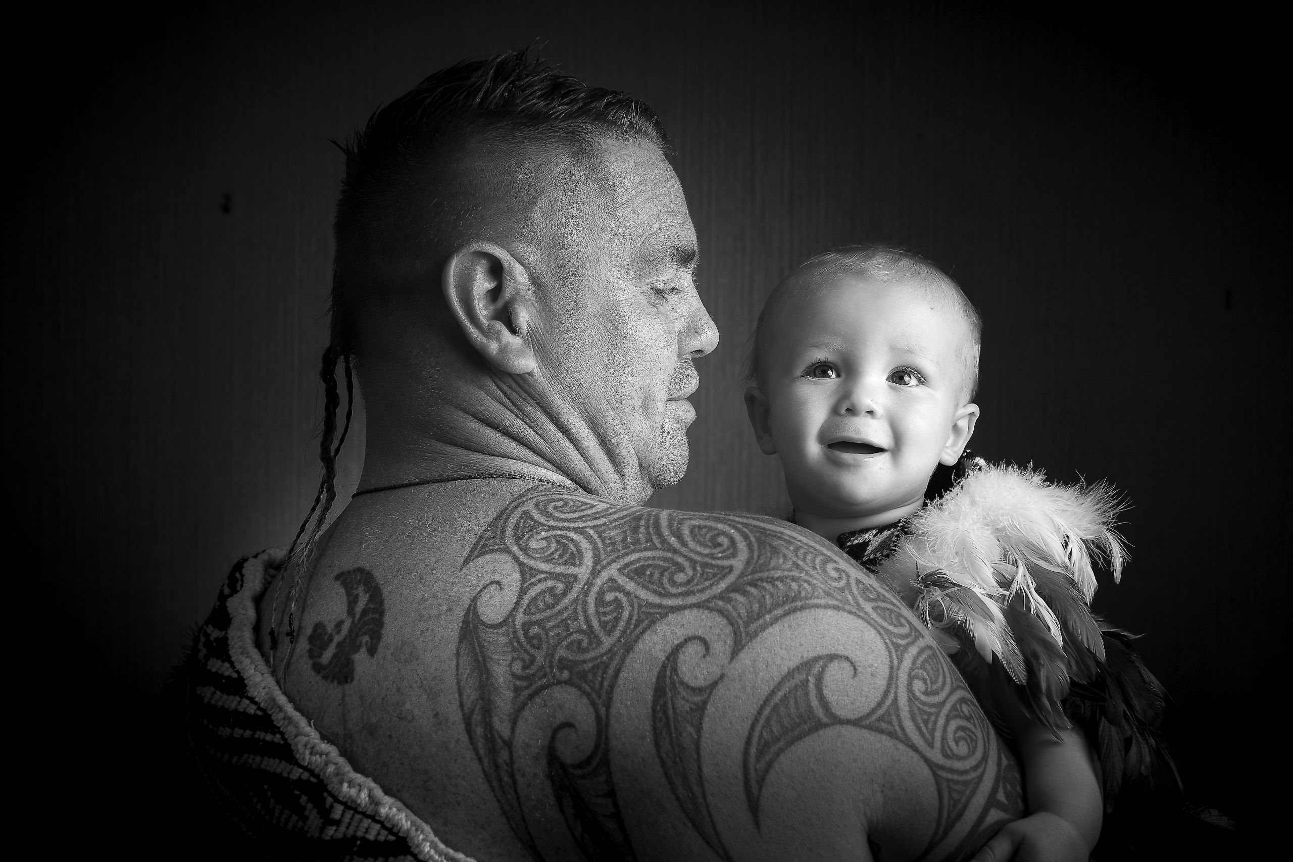Lyall Te Ohu holding his son.