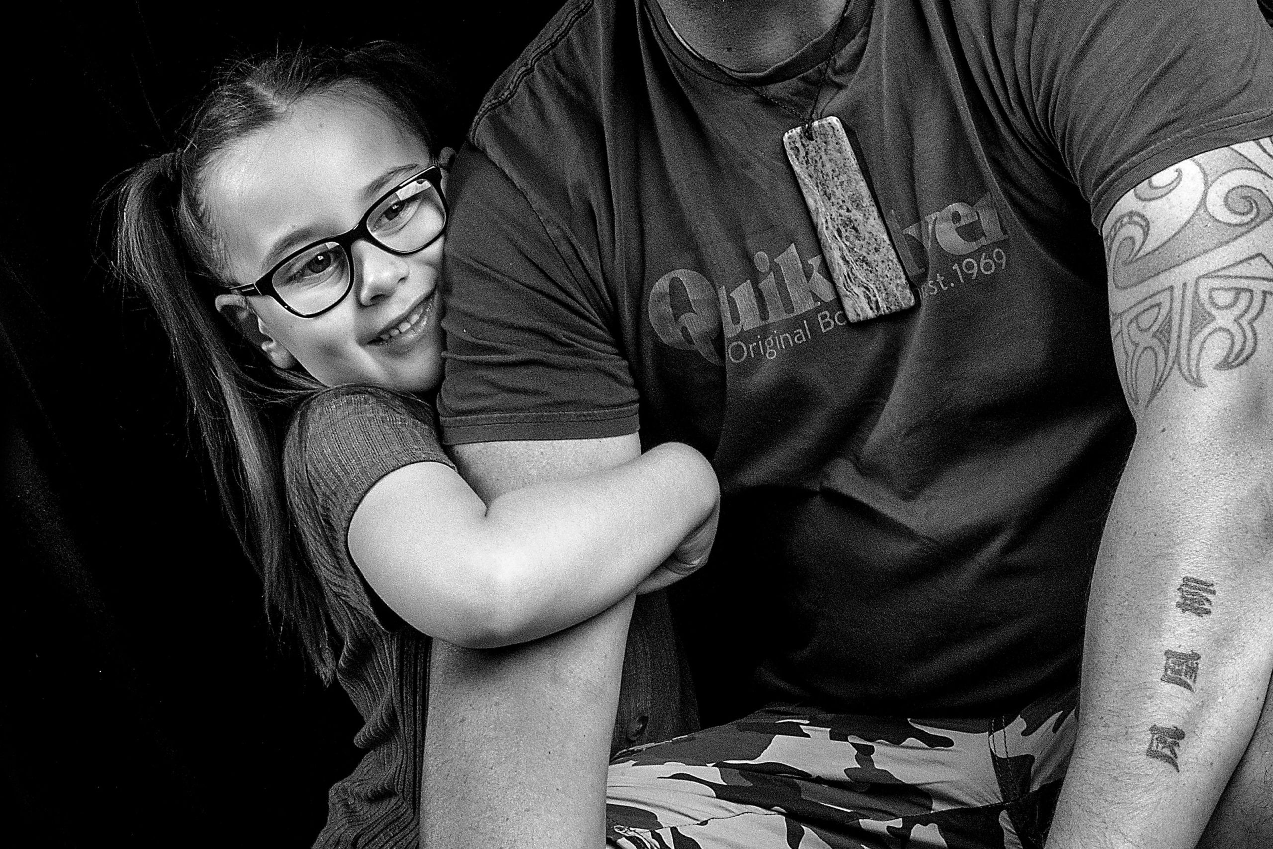 Willow hugging her father's arm.