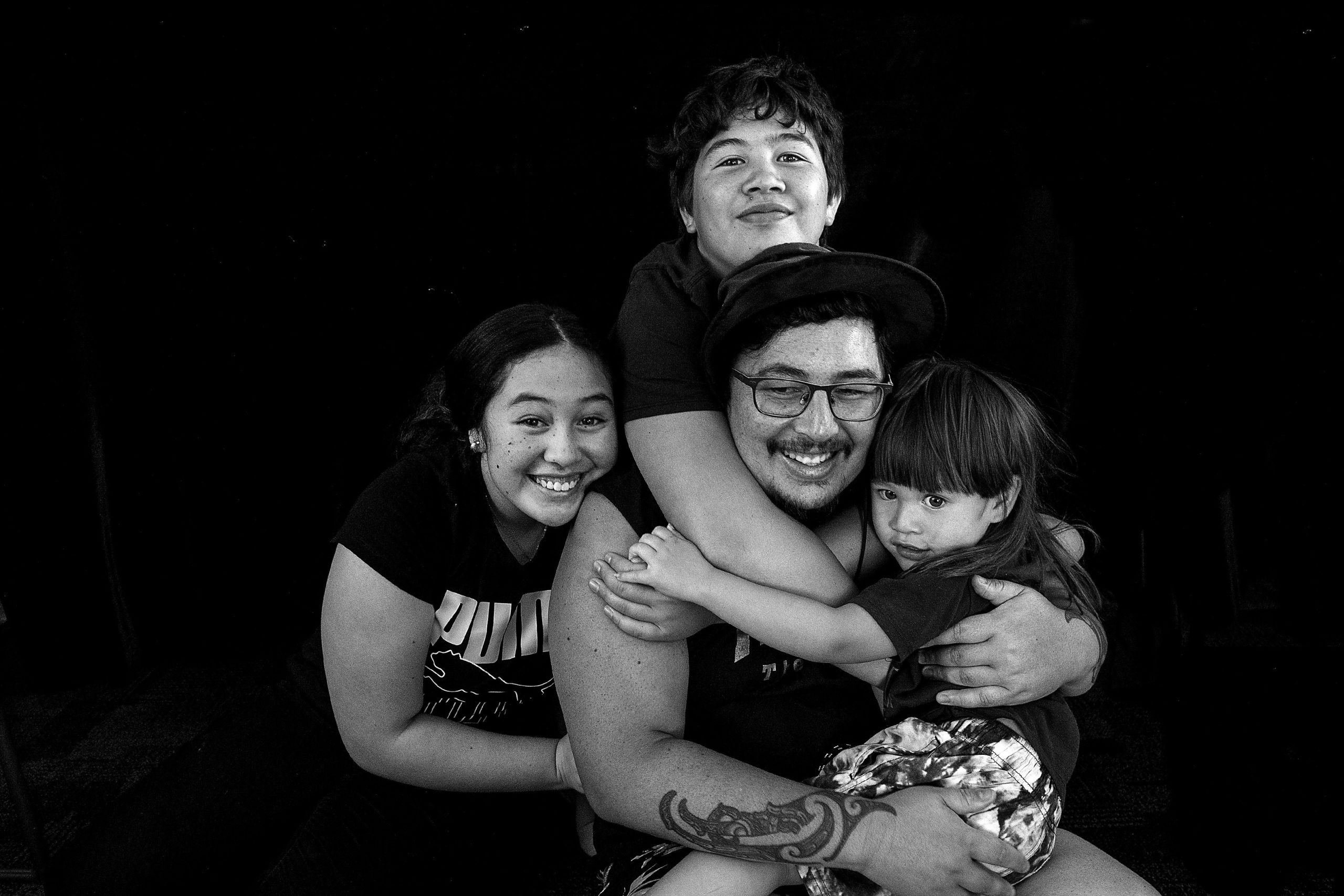 Te Moananui-A-Kiwa Goddard embraced by his children.