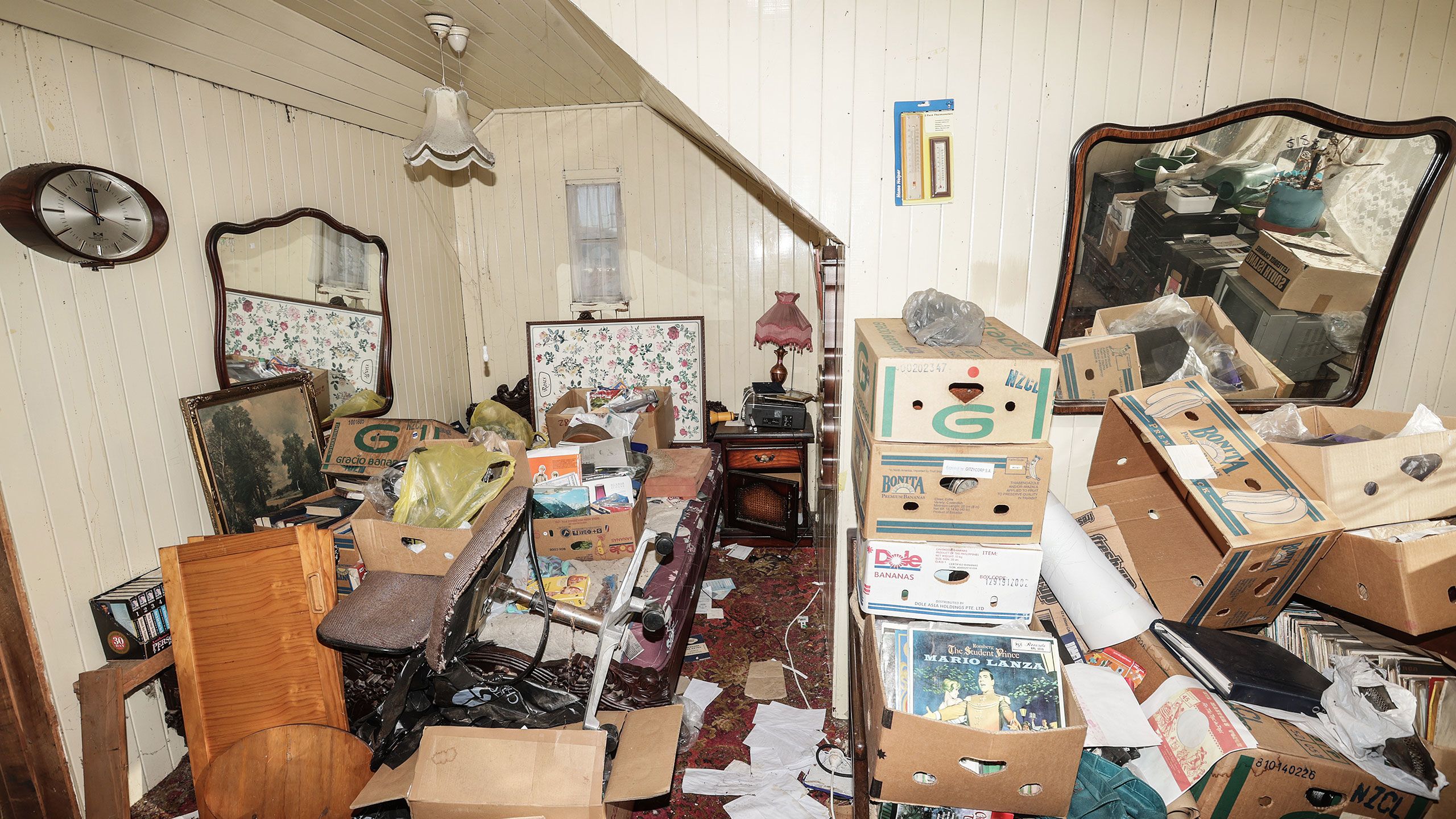 Another of the bedrooms, which is full of boxes of records and other junk.