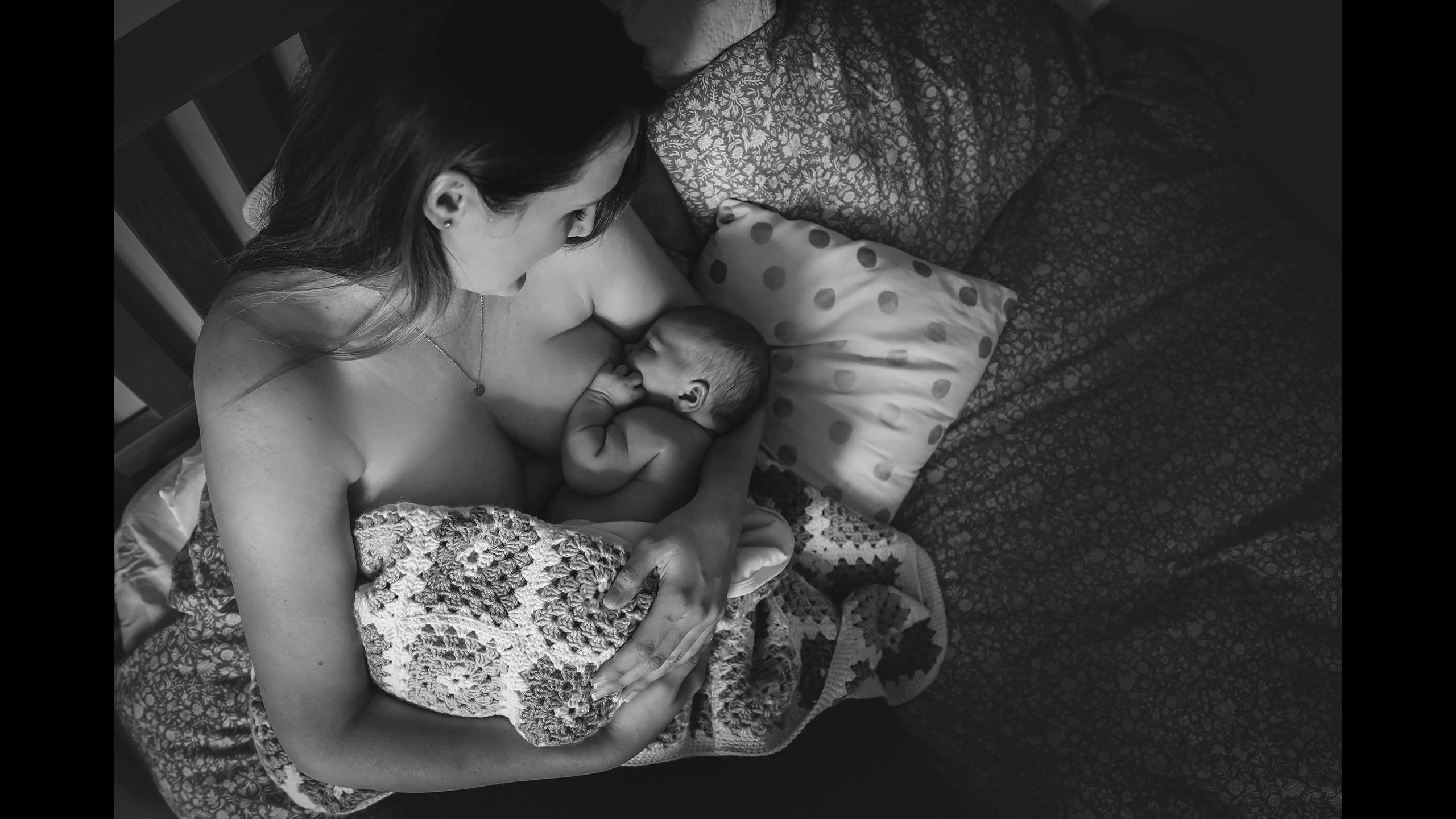 A closer overhead, intimate view of Jessica breastfeeding Hazel.