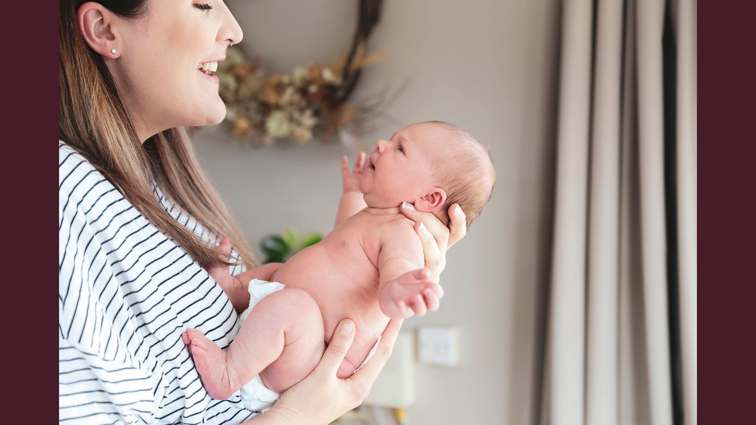 Jessica holds Hazel in arms so she she facing her. They are engaging with each other.