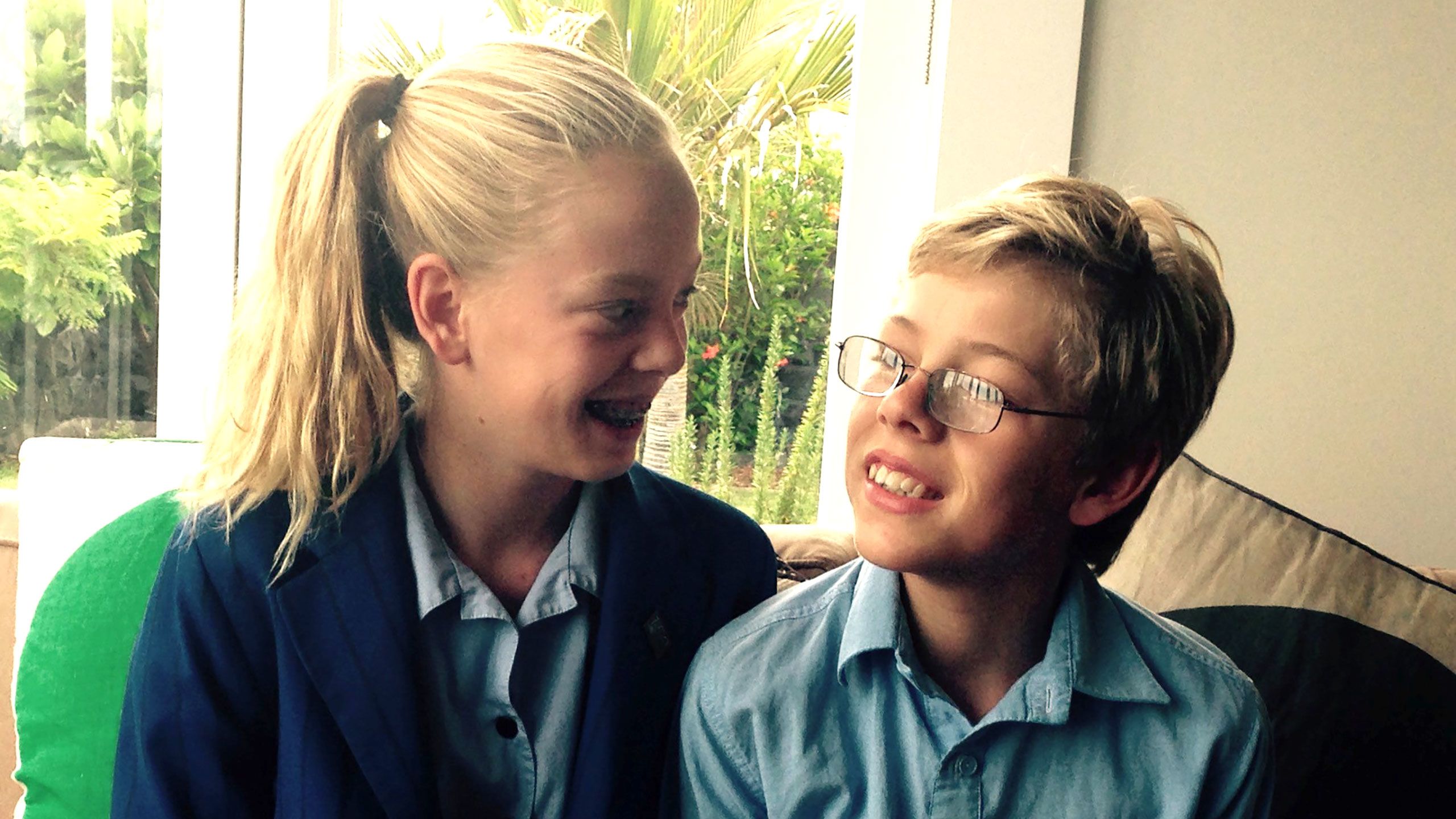 India and Mac Burns, now 13 sitting next to each other wearing their school uniforms.