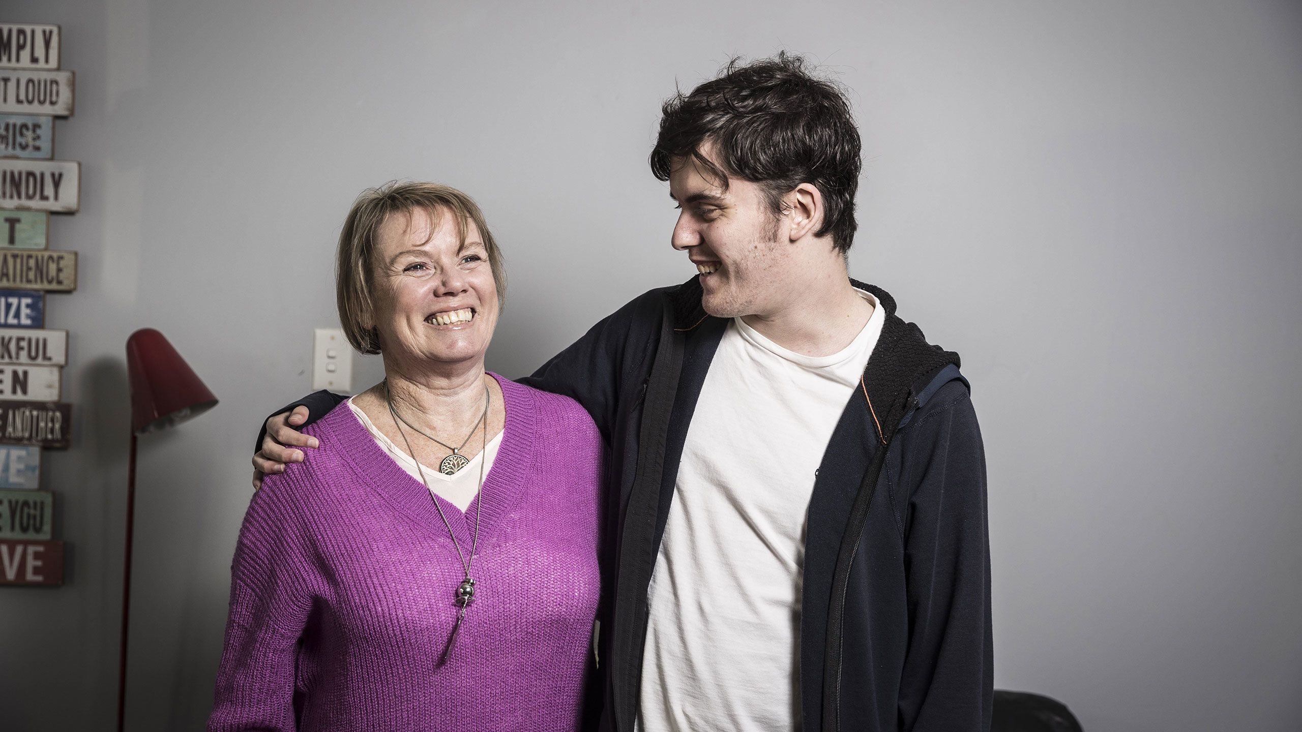 Saul Gallagher stands with one arm over the shoulder of his and his mum Yvonne.