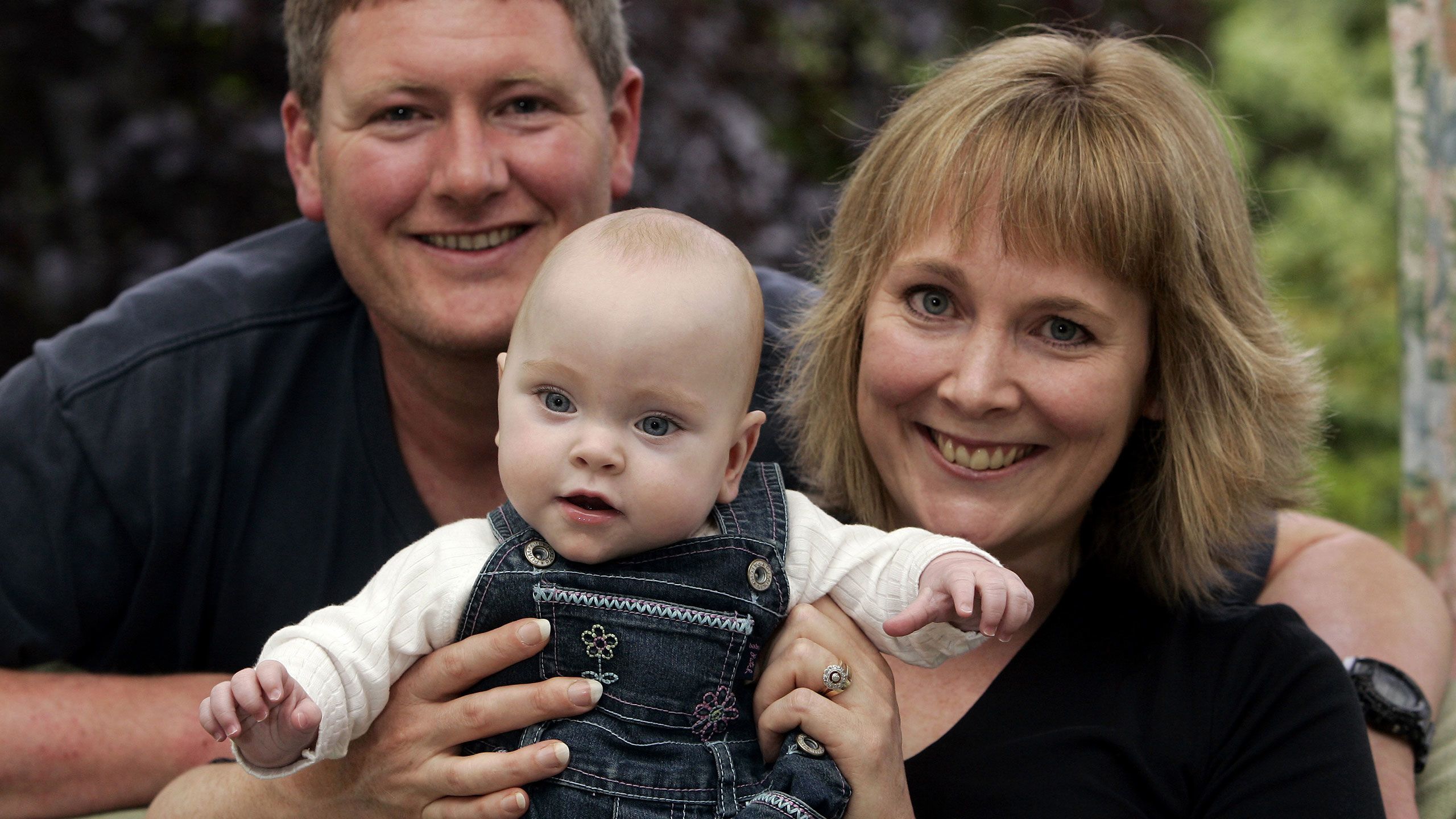 Portrait photo of John Dickson, Liz Rose with baby Charlotte