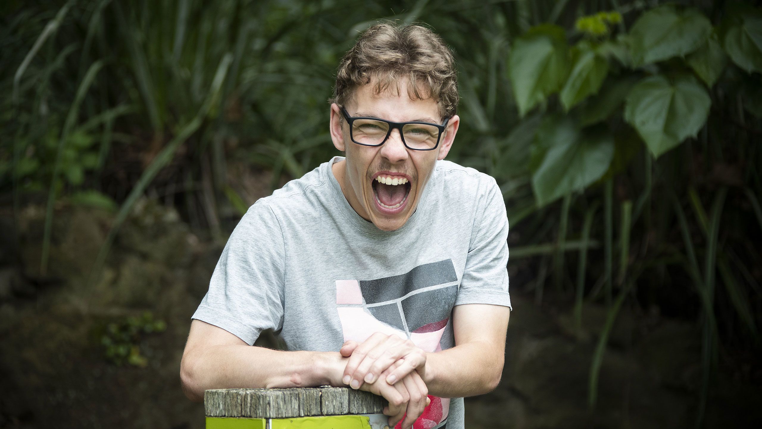 Portrait of Mac laughing loudly.