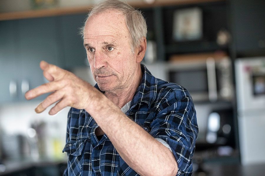 Mark gesticulates with left hand while discussing the story about his father disappearing.