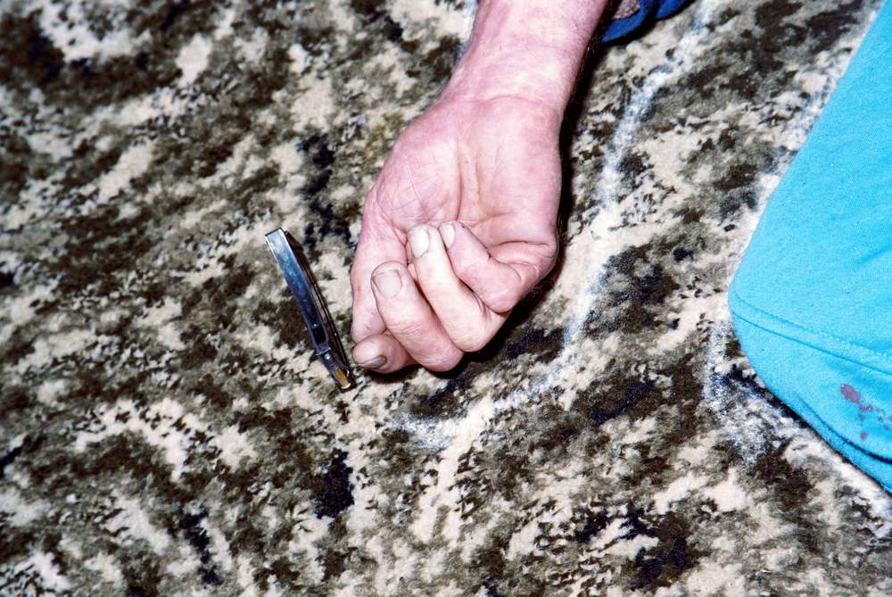 A magazine was found resting on its narrow side next to Robin Bain's hand. A magazine was found resting on its narrow side next to Robin Bain's hand.